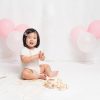 smiling girl at Huntingdon cake smash photography session