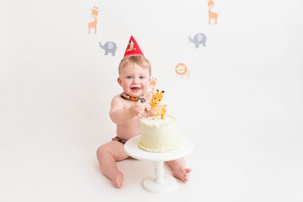 happy baby with cake at Huntingdon cake smash photography session