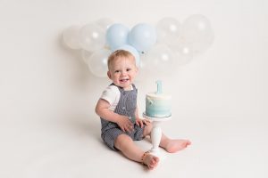 baby smiling with cake at Huntingdon cake smash photography session