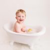 baby smiling in the bath during Huntingdon cake smash photography session